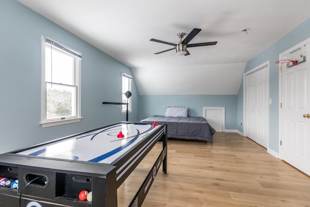 bedroom featuring lofted ceiling, ceiling fan, and light hardwood / wood-style flooring