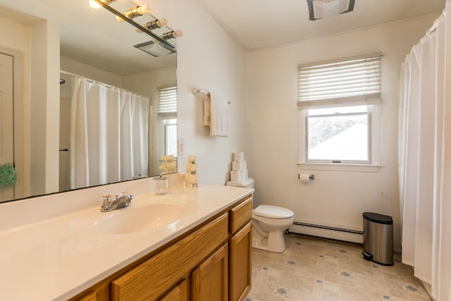 bathroom featuring a baseboard radiator, vanity, and toilet