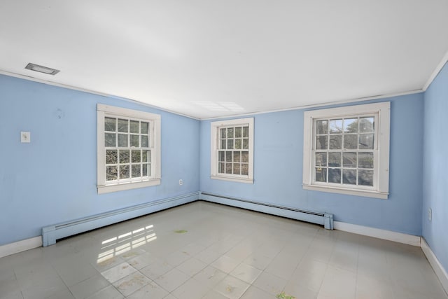 empty room featuring baseboard heating, a healthy amount of sunlight, baseboards, and visible vents