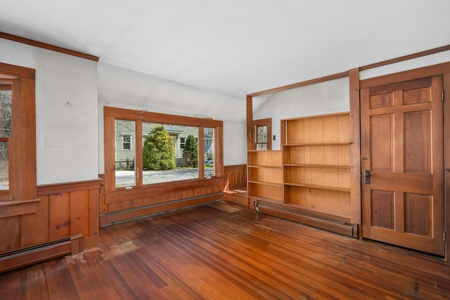 spare room featuring a baseboard radiator, hardwood / wood-style flooring, and lofted ceiling