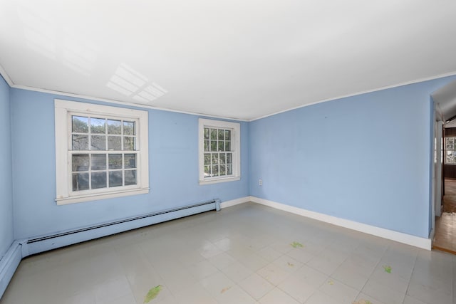 empty room featuring a baseboard heating unit, baseboards, and a healthy amount of sunlight