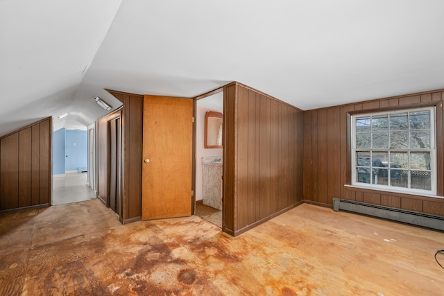 additional living space featuring wooden walls, a baseboard heating unit, and lofted ceiling