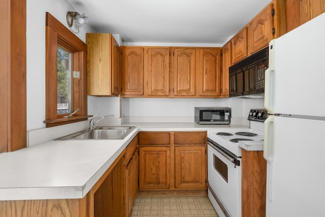kitchen featuring a sink, light countertops, white appliances, and brown cabinets