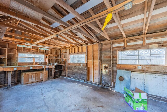 misc room with a workshop area and lofted ceiling
