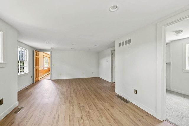 spare room with light hardwood / wood-style floors and baseboard heating