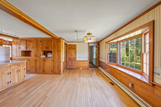 kitchen featuring baseboard heating, light hardwood / wood-style floors, pendant lighting, and white fridge