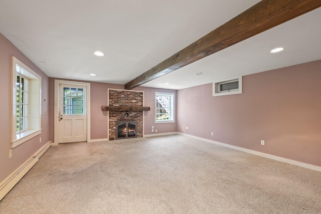 unfurnished living room featuring beamed ceiling, a brick fireplace, a baseboard heating unit, and light carpet