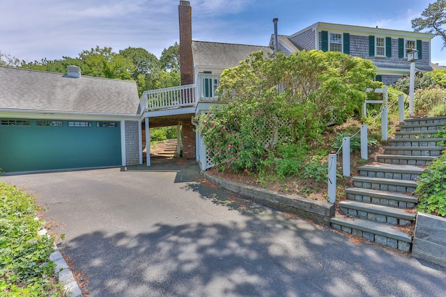 view of front facade featuring a garage and a wooden deck