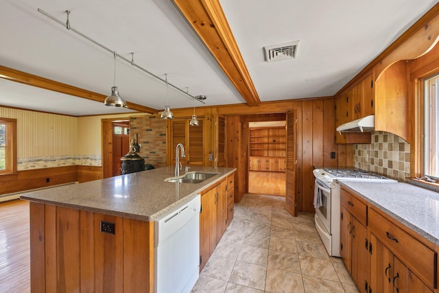 kitchen featuring baseboard heating, pendant lighting, white appliances, sink, and a kitchen island with sink