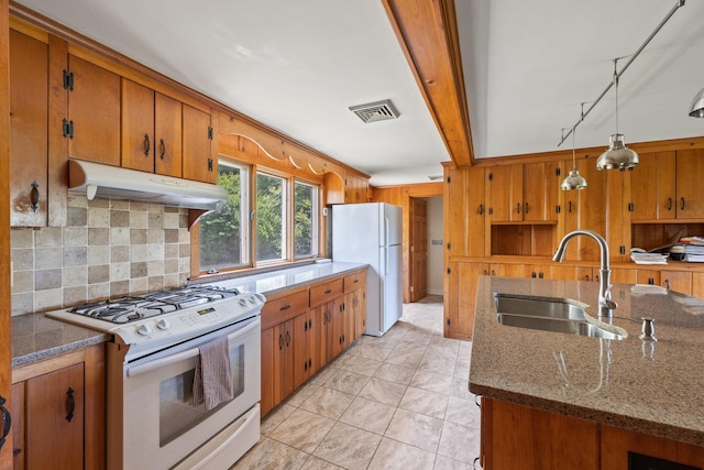 kitchen featuring beamed ceiling, white appliances, decorative backsplash, sink, and pendant lighting