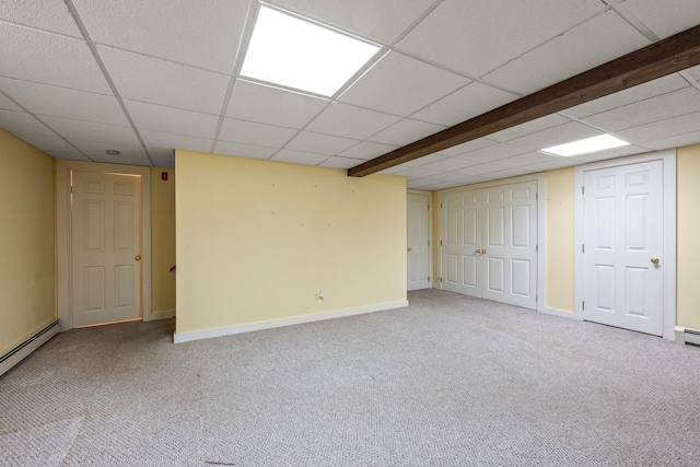 basement with carpet flooring and a baseboard heating unit