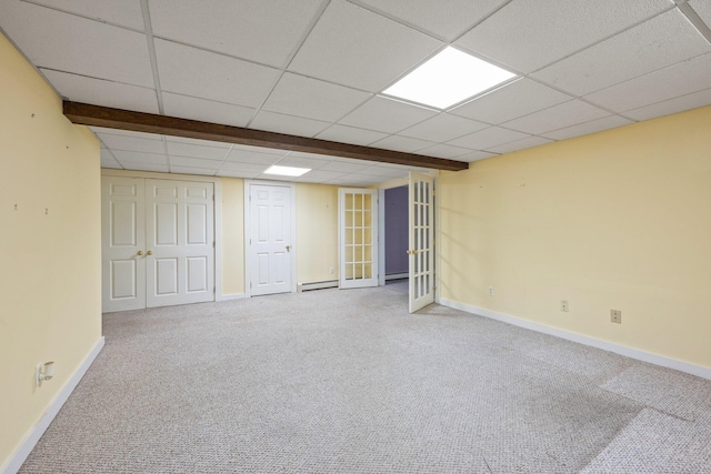 spare room featuring light colored carpet and a baseboard heating unit