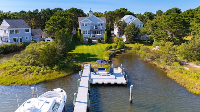 view of dock featuring a water view and a lawn