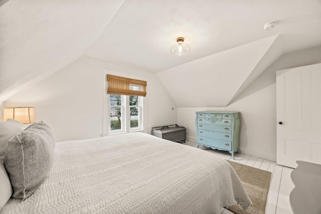 tiled bedroom featuring lofted ceiling