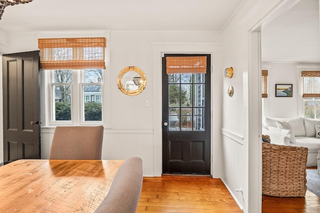 entrance foyer featuring ornamental molding and light hardwood / wood-style floors