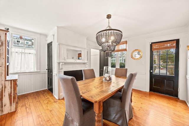 dining space featuring a notable chandelier and light hardwood / wood-style flooring