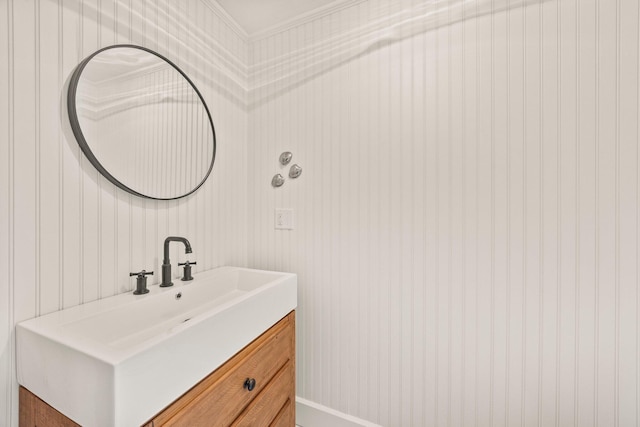 bathroom with crown molding and vanity