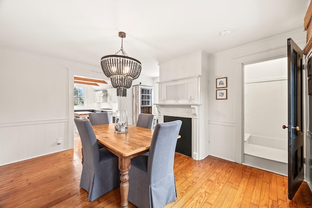 dining room featuring a chandelier and light wood-type flooring