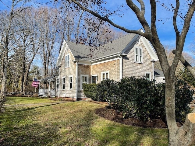 view of side of home featuring a lawn