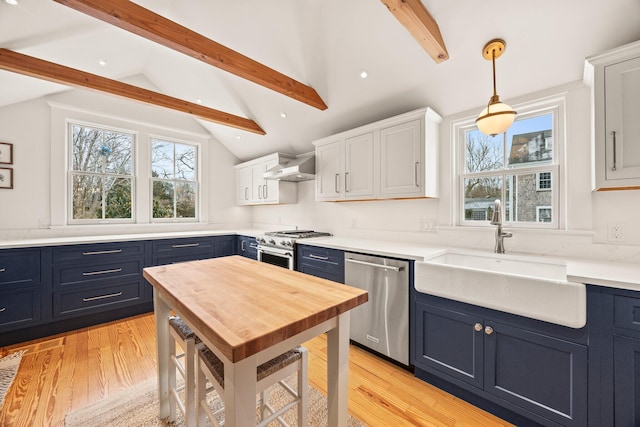 kitchen with blue cabinetry, sink, white cabinetry, appliances with stainless steel finishes, and pendant lighting