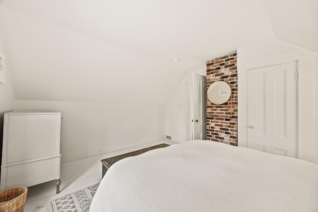 bedroom with vaulted ceiling and a closet