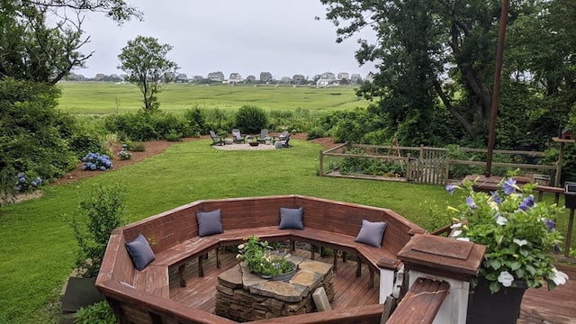 view of patio / terrace with a wooden deck and an outdoor fire pit