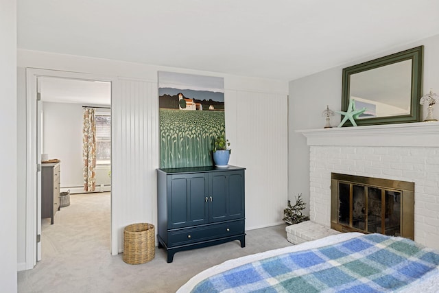 bedroom featuring a baseboard radiator, carpet floors, and a fireplace