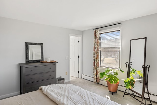 bedroom with light colored carpet and baseboards