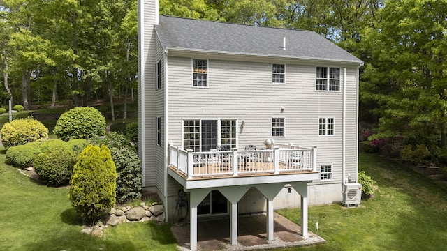 2181 Service Rd, West Barnstable, MA 02668 - back of property with a yard, a chimney, a wooden deck, and a shingled roof