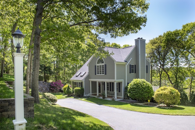 2181 Service Rd, West Barnstable, MA 02668 - view of front of home featuring a front yard, a chimney, and a shingled roof