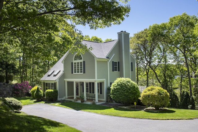2181 Service Rd, West Barnstable, MA 02668 - view of front facade featuring a chimney, a front lawn, and roof with shingles