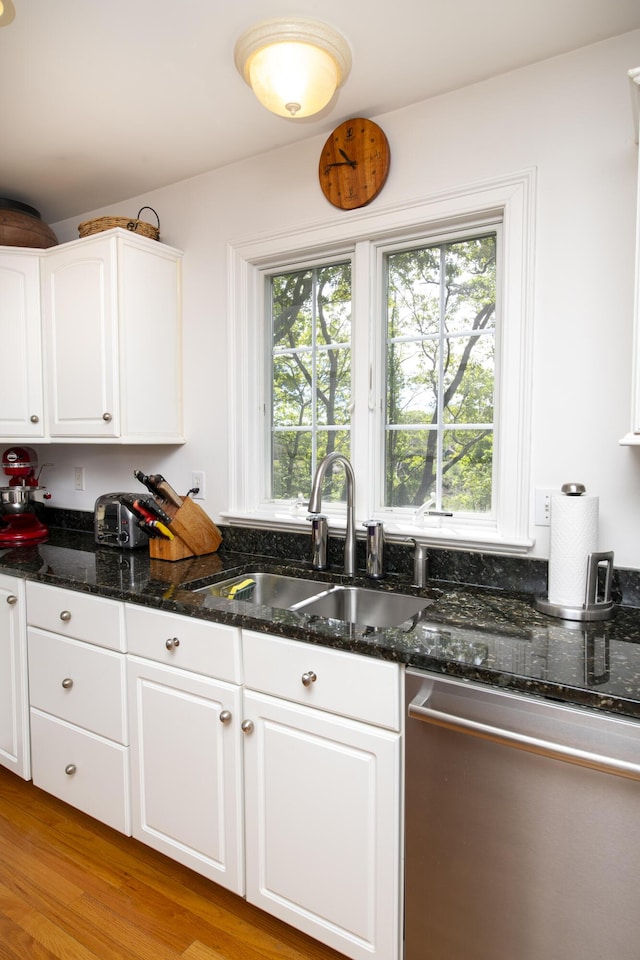 2181 Service Rd, West Barnstable, MA 02668 - kitchen with stainless steel dishwasher, a sink, white cabinetry, and dark stone countertops