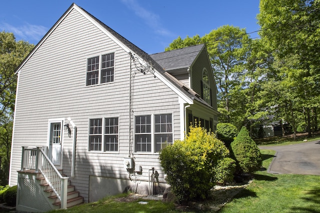 2181 Service Rd, West Barnstable, MA 02668 - view of side of property featuring roof with shingles and a yard