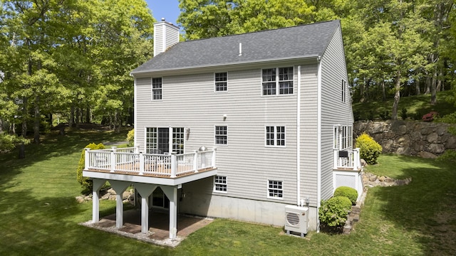 2181 Service Rd, West Barnstable, MA 02668 - back of property with a cooling unit, a chimney, a yard, and a deck