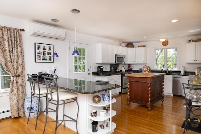 2181 Service Rd, West Barnstable, MA 02668 - kitchen featuring appliances with stainless steel finishes, a wall mounted air conditioner, open shelves, white cabinetry, and recessed lighting