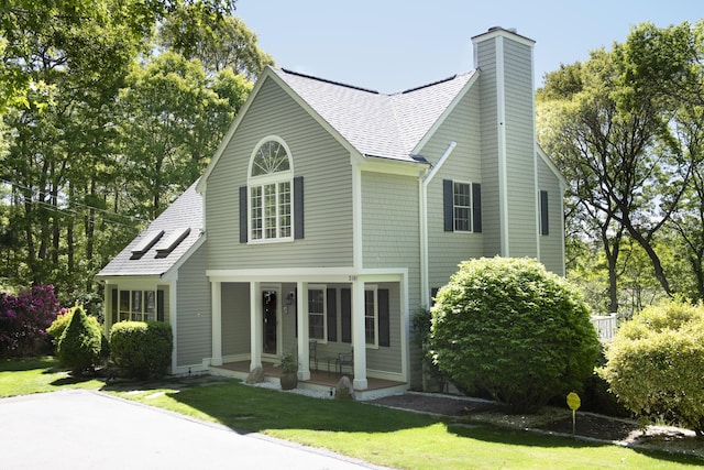 2181 Service Rd, West Barnstable, MA 02668 - view of front of property with a shingled roof, a front lawn, and a chimney