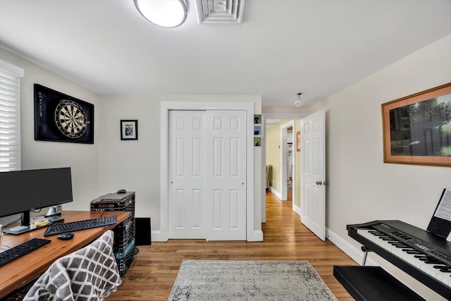office space with baseboards and wood finished floors