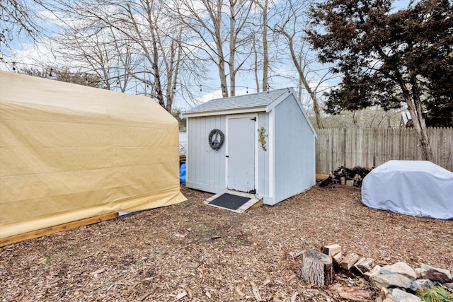 view of shed with fence