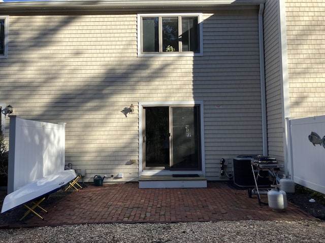 entrance to property featuring a patio area and central air condition unit