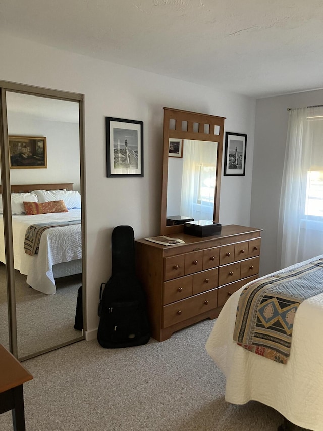 bedroom featuring light carpet