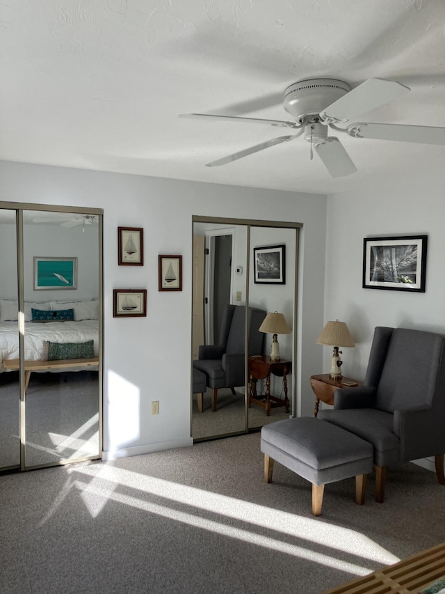 living area with ceiling fan and carpet floors