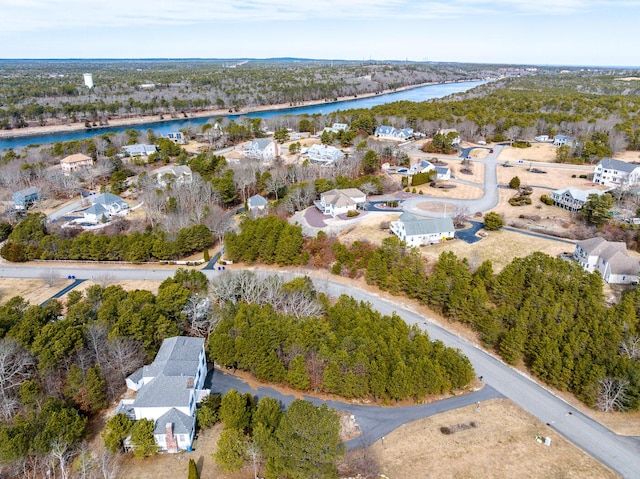 birds eye view of property featuring a water view and a view of trees