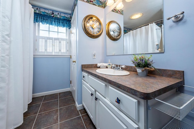 bathroom featuring vanity, tile patterned floors, and baseboards