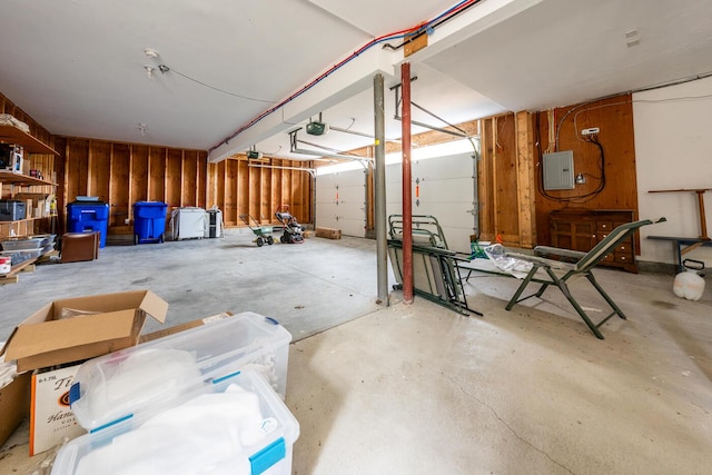 garage with electric panel and a garage door opener