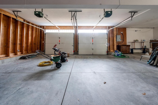 garage featuring electric panel and a garage door opener