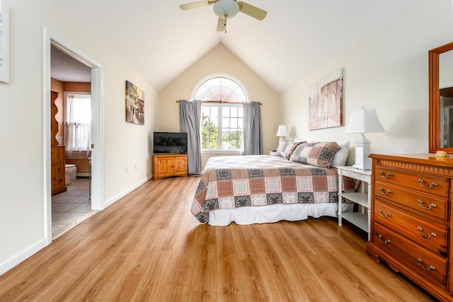 bedroom featuring baseboards, light wood-style floors, a ceiling fan, and vaulted ceiling