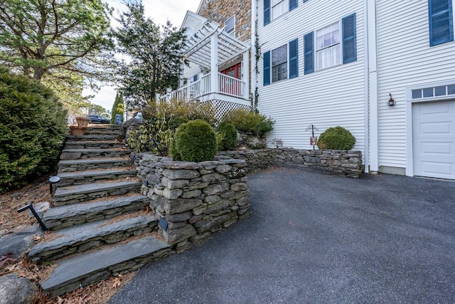 exterior space featuring stairs and a garage