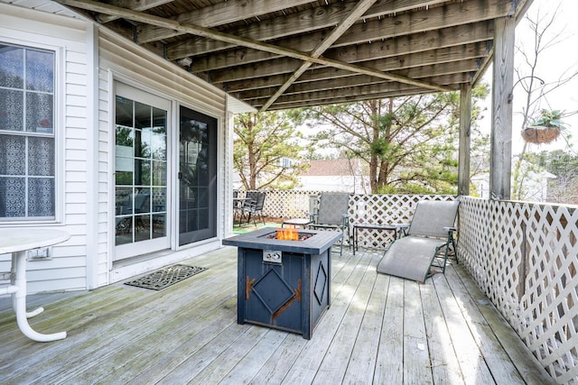 wooden terrace featuring a fire pit