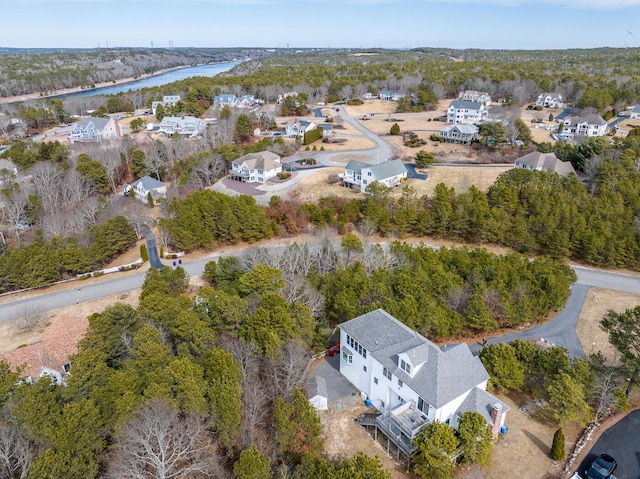 drone / aerial view with a view of trees and a water view