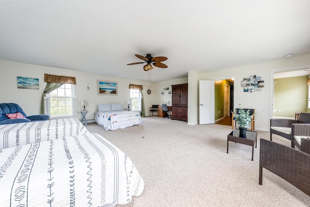 bedroom with ceiling fan, baseboards, and carpet